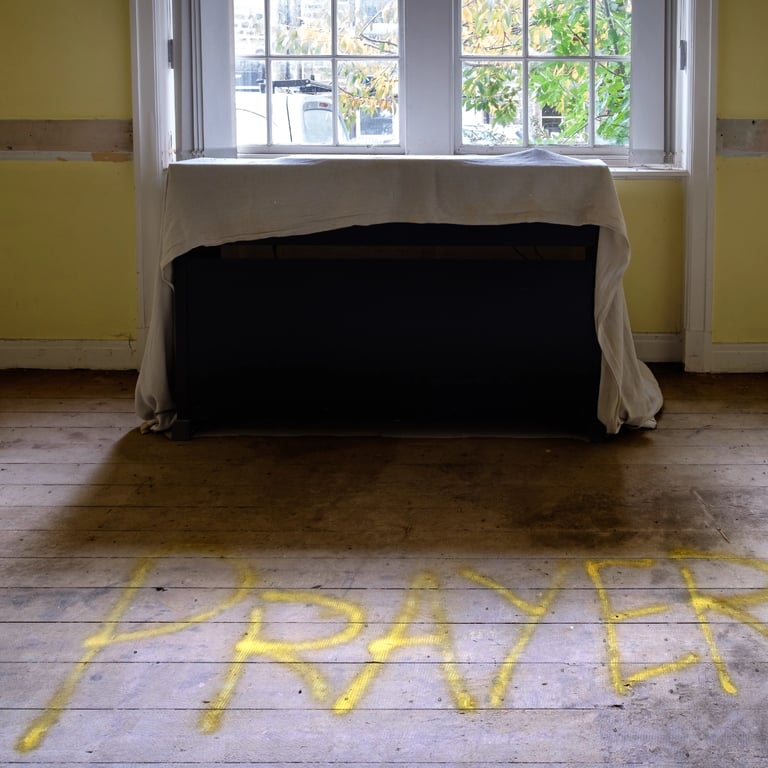 Cover piano by window with work prayer sprayed on floor