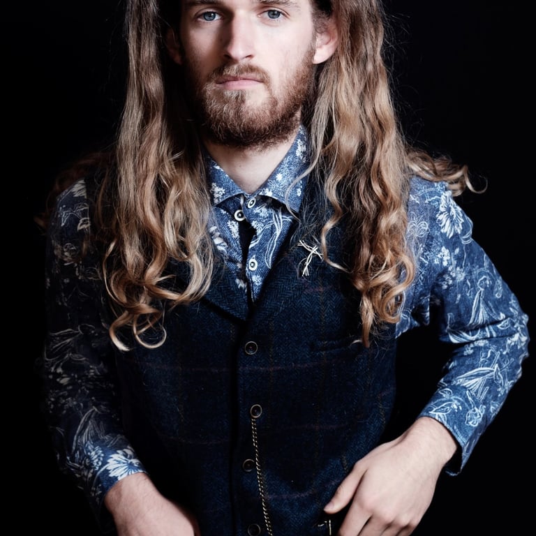 Man with long hair in waistcoat