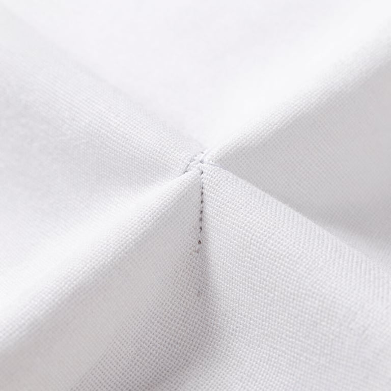 Macro close-up shot of heavy canvas weave and precise double-stitched seams, bright high-key lighting, soft natural daylight, 50mm