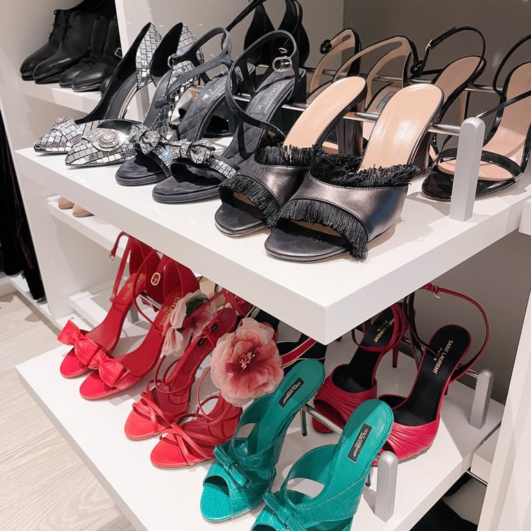 Shoes in a master closet organized by color.