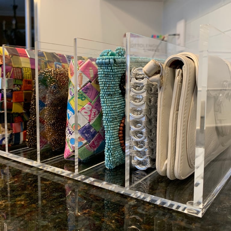 Clutch purses in a purse holder to keep them neat and tidy.