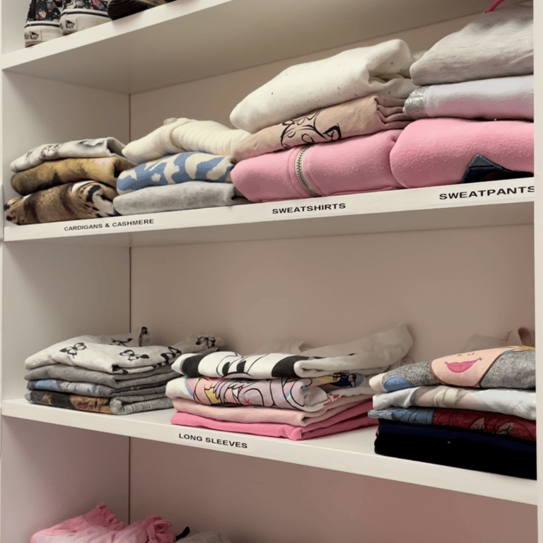 Kids closet with clothing organized and arranged by color and type.