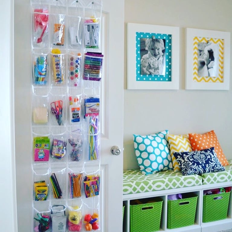 Playroom area with craft supplies neatly organized in storage pockets and bins under the colorful organized bench.