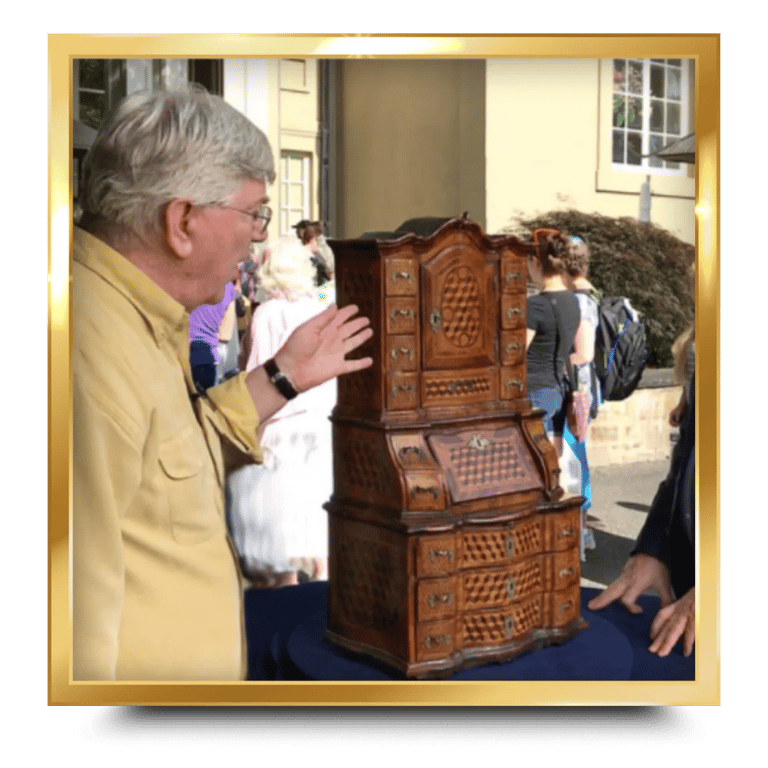 Dr. Glenn P. Wood standing next to a tall antique wooden cabinet