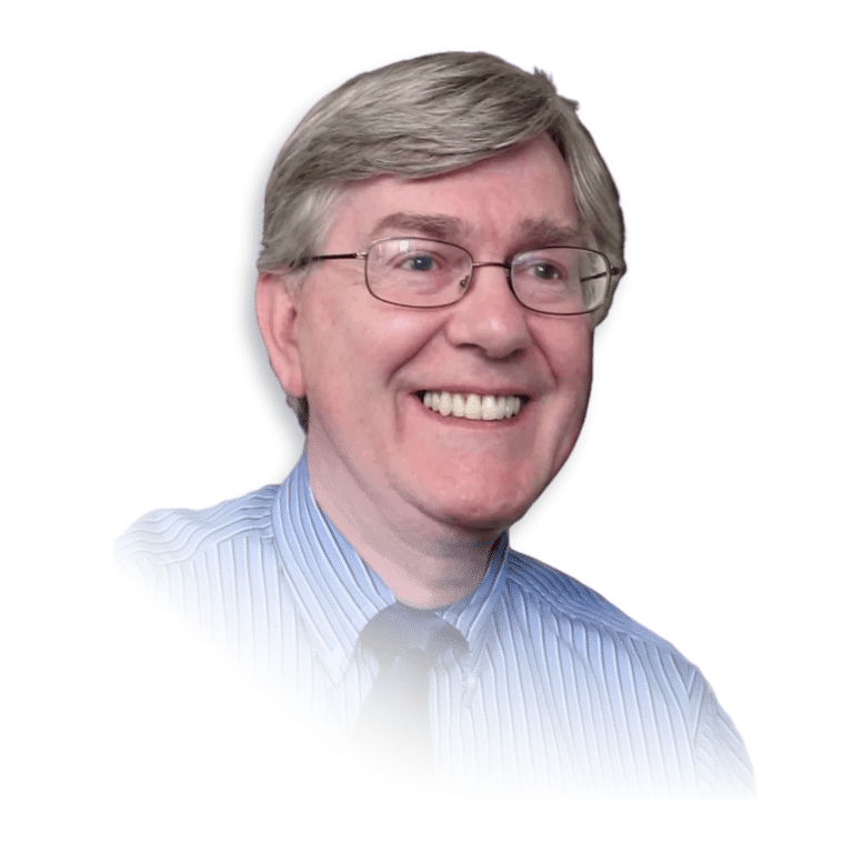 Dr. Glenn P. Wood in a blue shirt and tie smiling