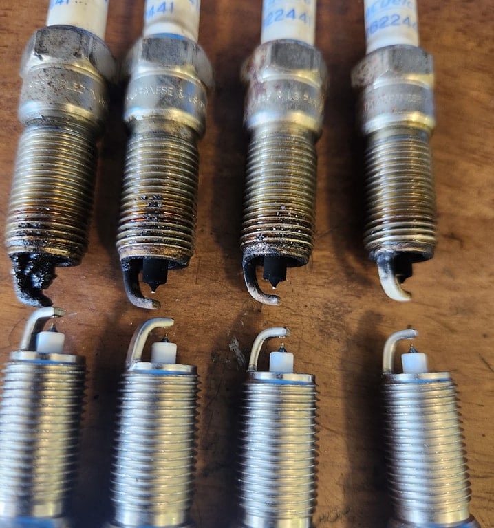 Worn-out plugs being replaced with new plugs at Winston's Complete Auto Care in Cuyahoga Falls, Ohio