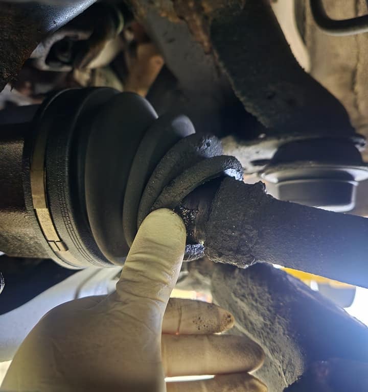 Mechanic showing suspension problem to customer at Winston's Complete Auto Care in Cuyahoga Falls, Ohio