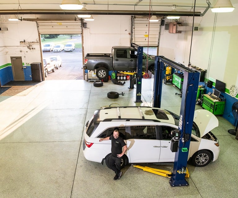 Nate Winston in the garage bay at Winston's Complete Auto Care in Cuyahoga Falls, Ohio.