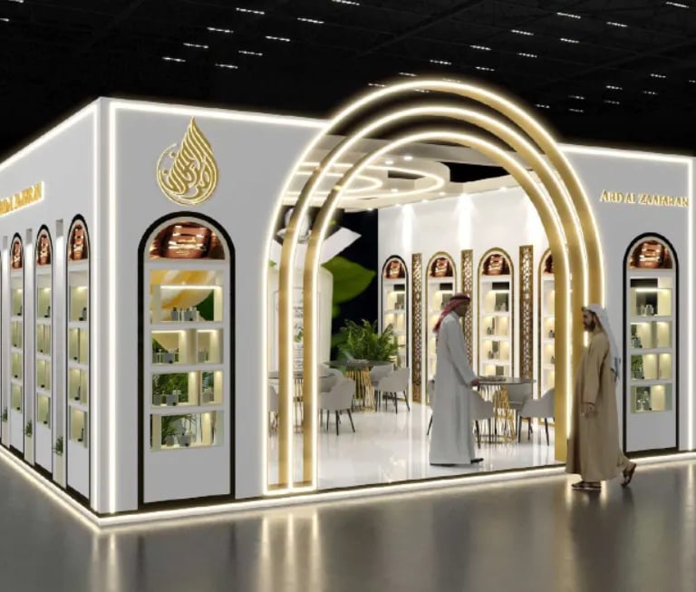 Luxury Ard Al Zaafaran booth by World Expo Pro: Elegant white structure, glowing gold arches, and bespoke perfume displays.