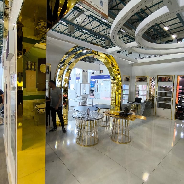 Bespoke gold mirror arches and circular ceiling design by World Expo Pro for a luxury Ard Al Zaafaran exhibit.