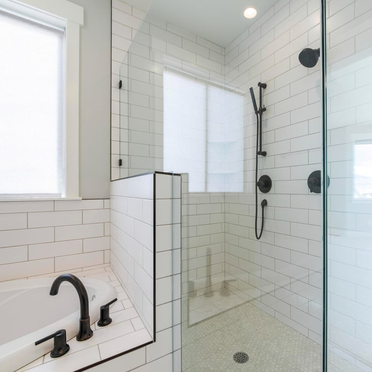 Modern tiled bathroom with glass shower and bath – indicates the end result after FixShowers install