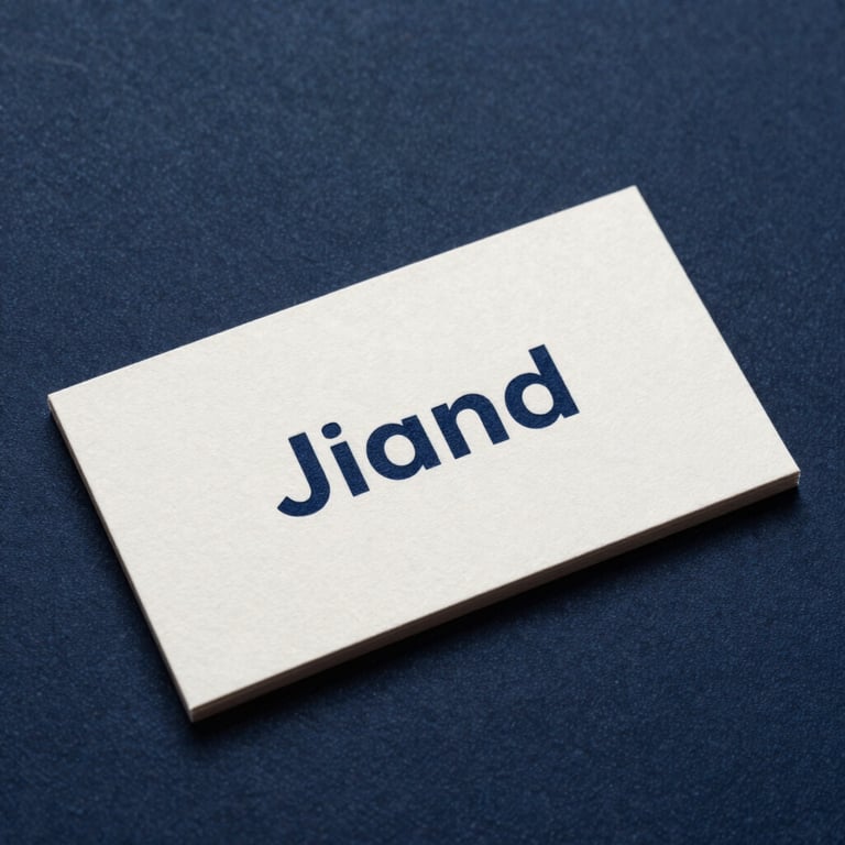 A crisp off-white business card with dark navy text resting on a dark navy textured surface.