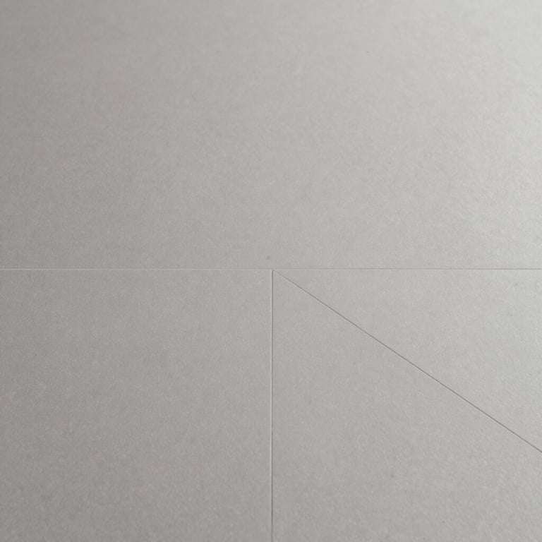 Samples of modern ceramic floor tiles in neutral grey tones, showcasing variety and quality.