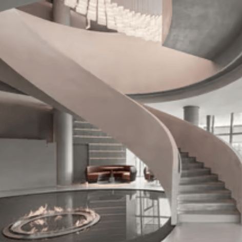 Modern luxury hotel lobby featuring a curved spiral staircase and an indoor circular fire pit.