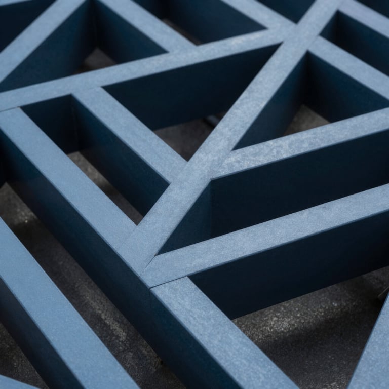 A close-up of complex 3D architectural geometry, using sharp lines and a modern Steel Blue and Deep Navy color scheme.