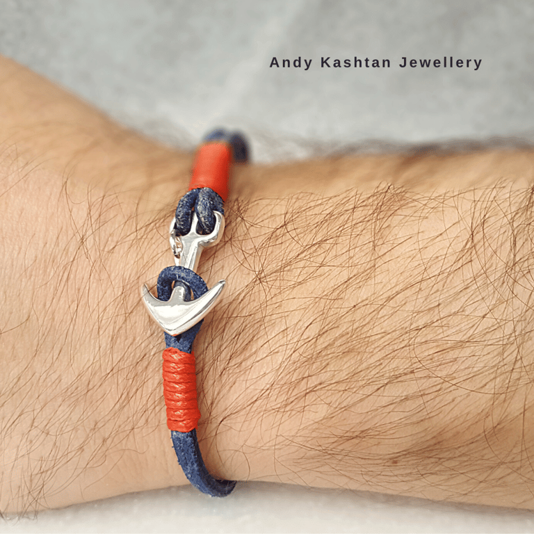 Handmade men's silver anchor bracelet with navy blue and red leather cord on a wrist.