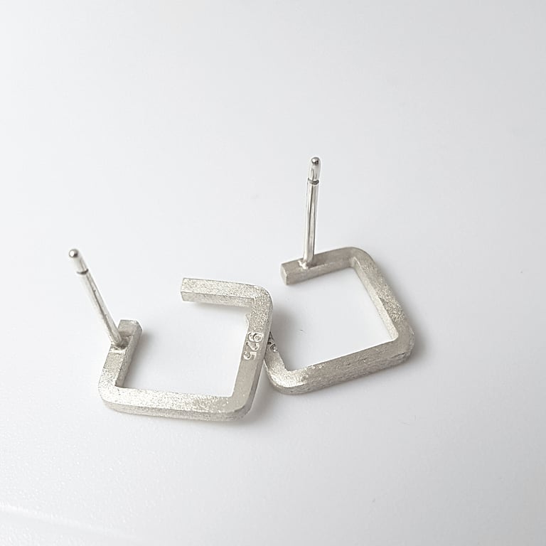 Handmade 925 sterling silver square stud earrings with a brushed matte finish on a white background.