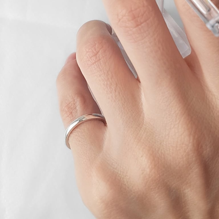 a person's hand with a ring on it