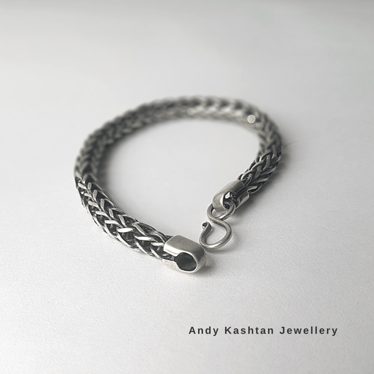 Handmade braided sterling silver chain bracelet with a secure hook clasp on a clean white background.