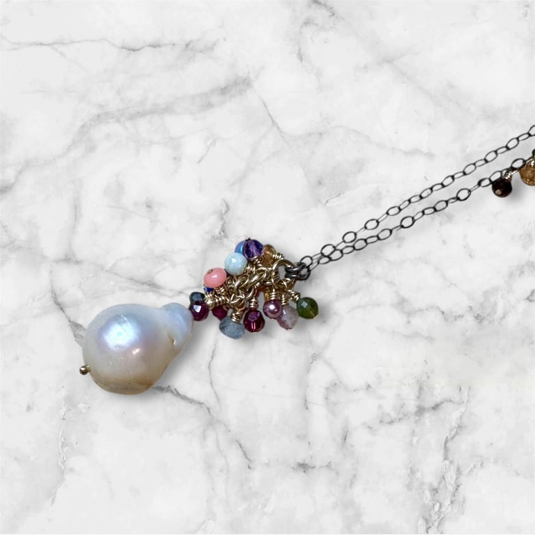 a necklace with a pearl and pearls on it
