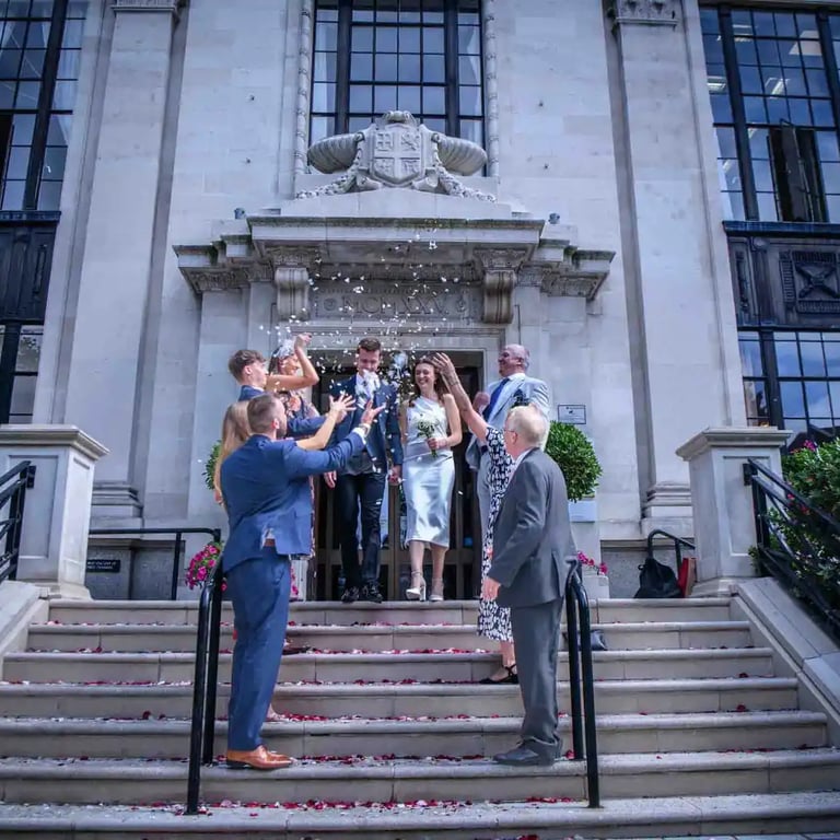 wedding couple having their confetti moment outside Islington Town Hall