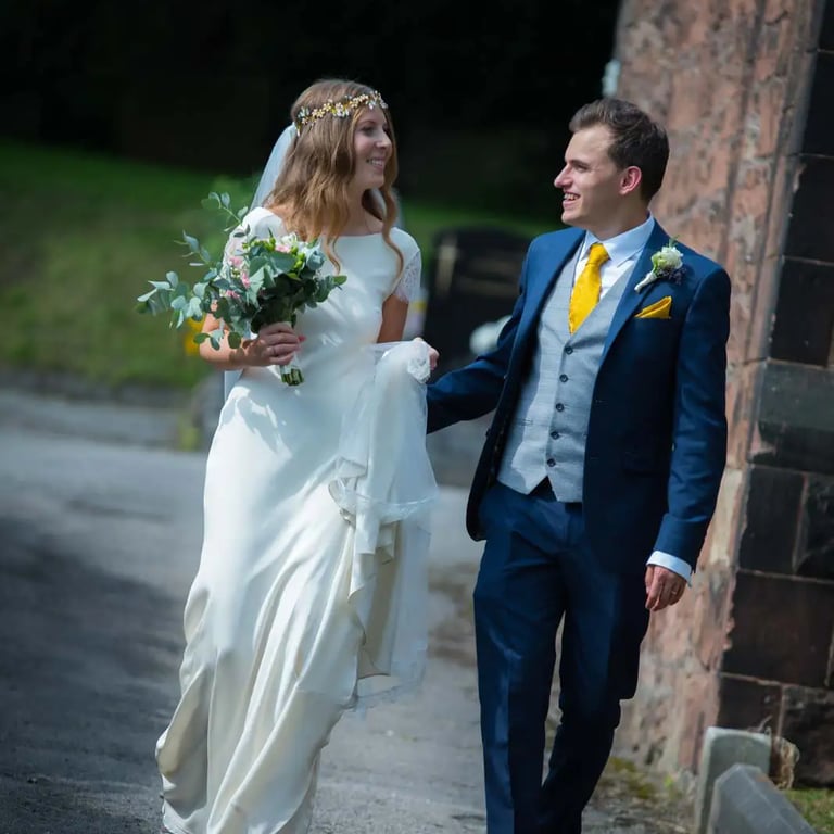 bride and groom walking around church grounds