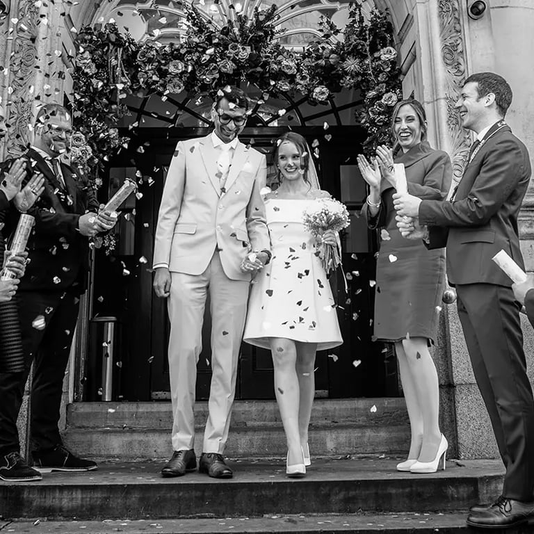 wedding couple walking down the stairs of Chelsea old town hall