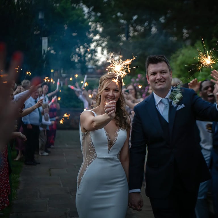 bride and groom holding sparklers