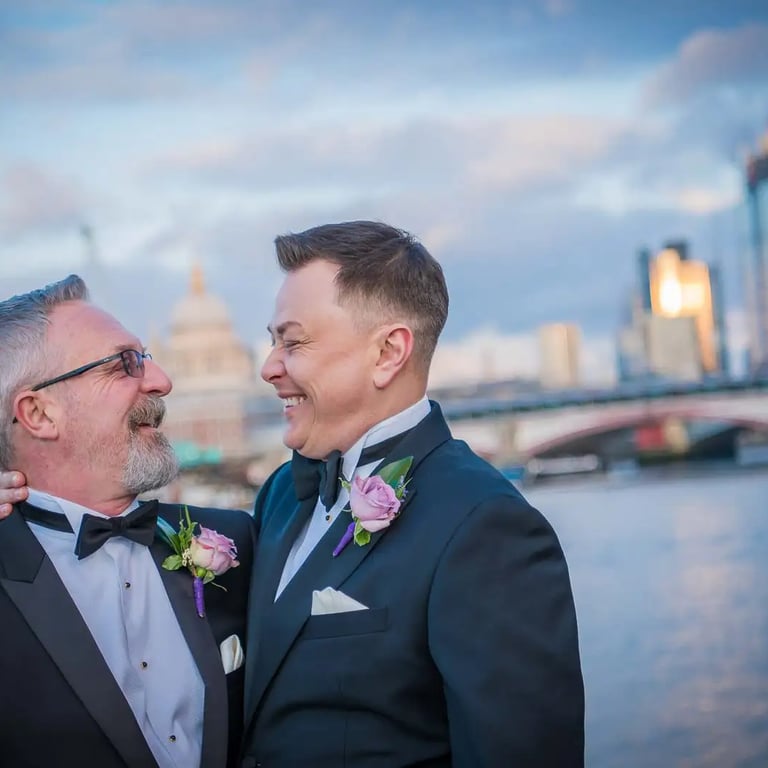 two grooms smiling at each other