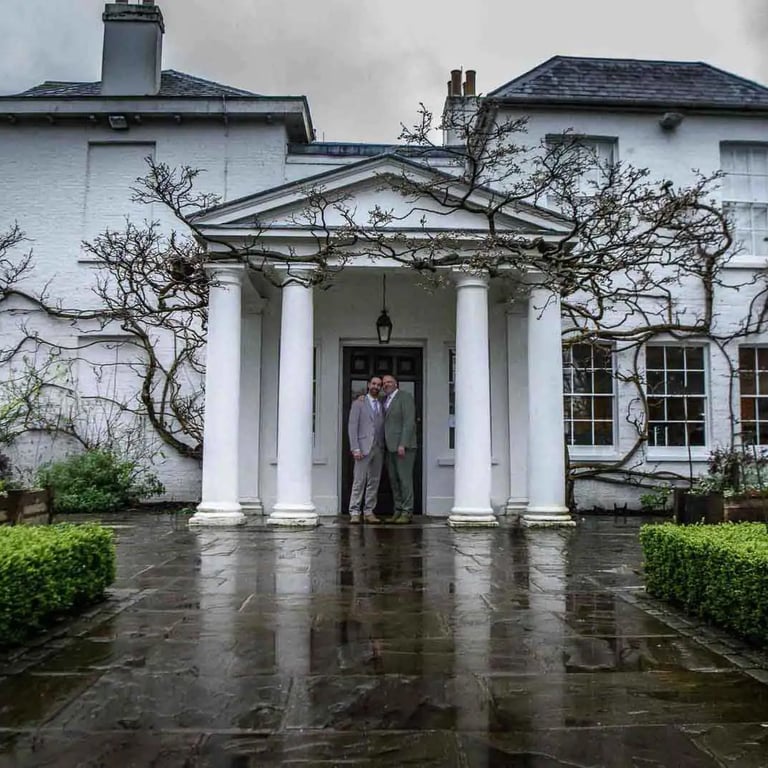 two grooms standing at the front door of Pembroke Lodge, Richmond