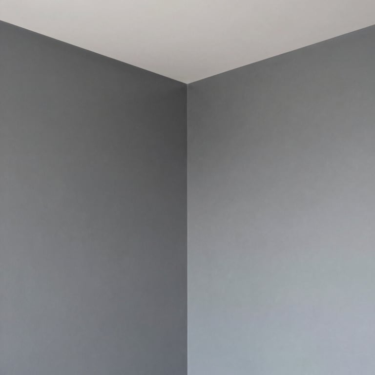 The corner of a modern bedroom showing perfectly straight lines between the ceiling and clouds grey walls.