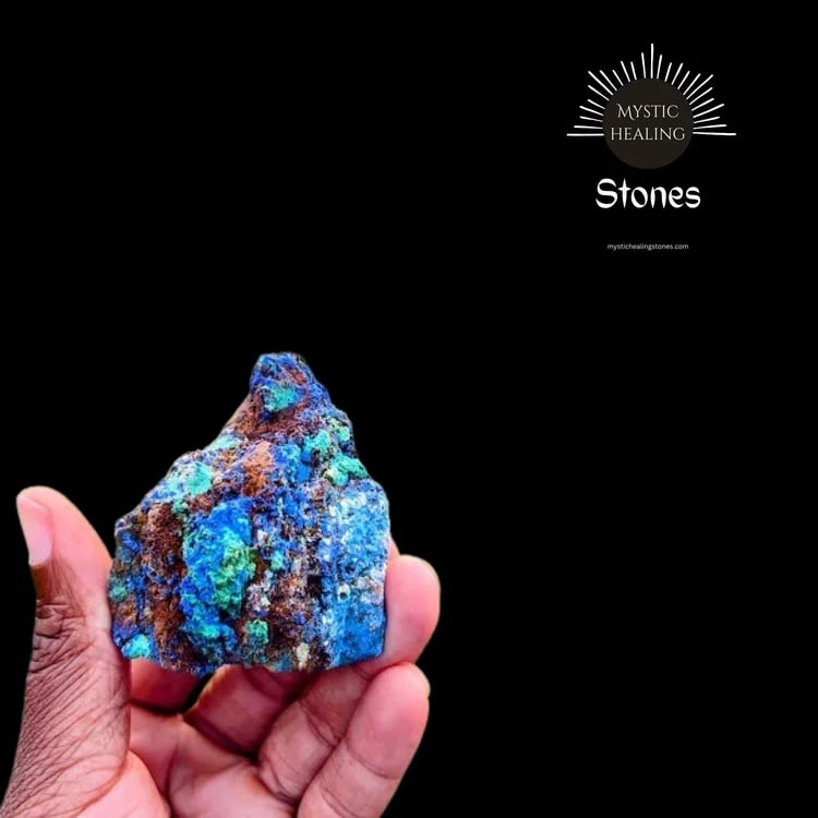 A person holding a raw blue azurite and green malachite crystal specimen for mystic healing.