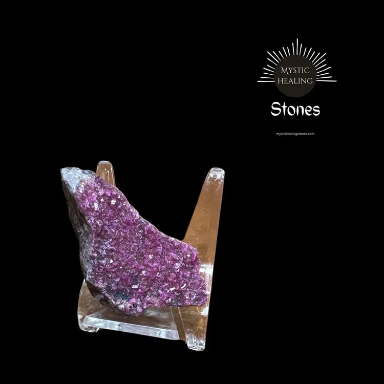 Cobaltoan Calcite crystal cluster displayed on a clear acrylic stand against a black background.