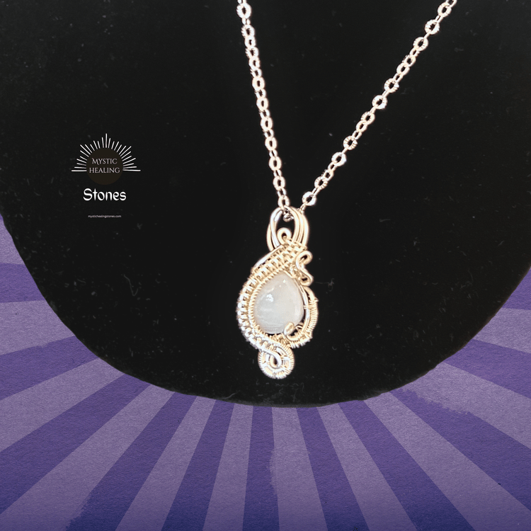 Handmade wire wrapped moonstone pendant necklace on a silver chain for crystal healing jewelry.