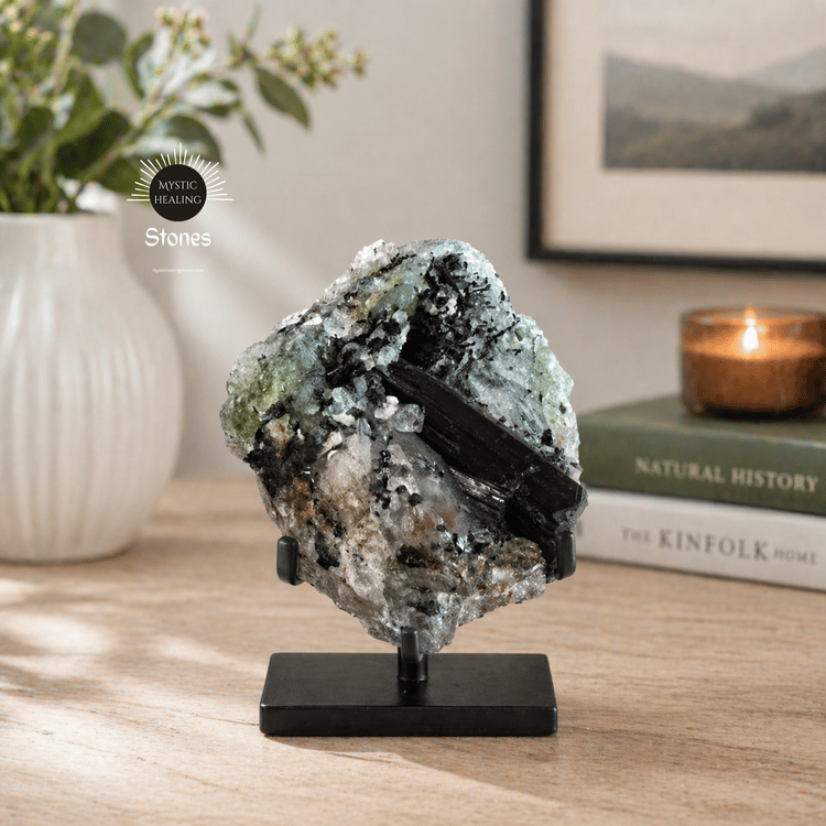 A raw black tourmaline in quartz crystal cluster displayed on a black metal stand for home decor.