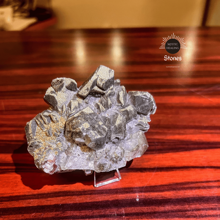 Raw pyrite on calcite on a wooden table, natural metallic luster and healing stone properties.