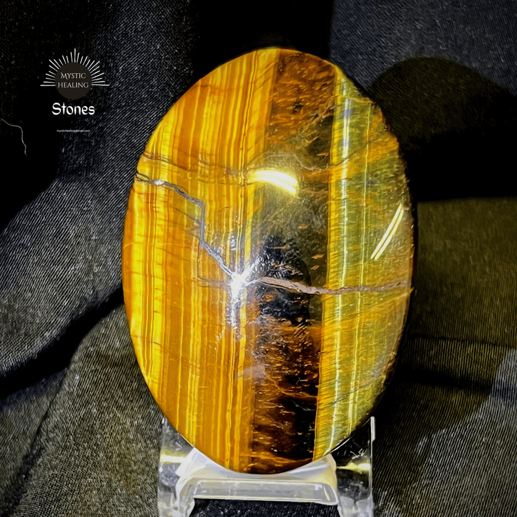 Polished oval tiger's eye healing crystal with golden chatoyant bands on a clear stand.