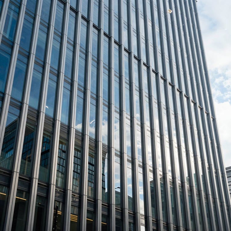 Modern architecture of a corporate building with glass and silver blue reflections.