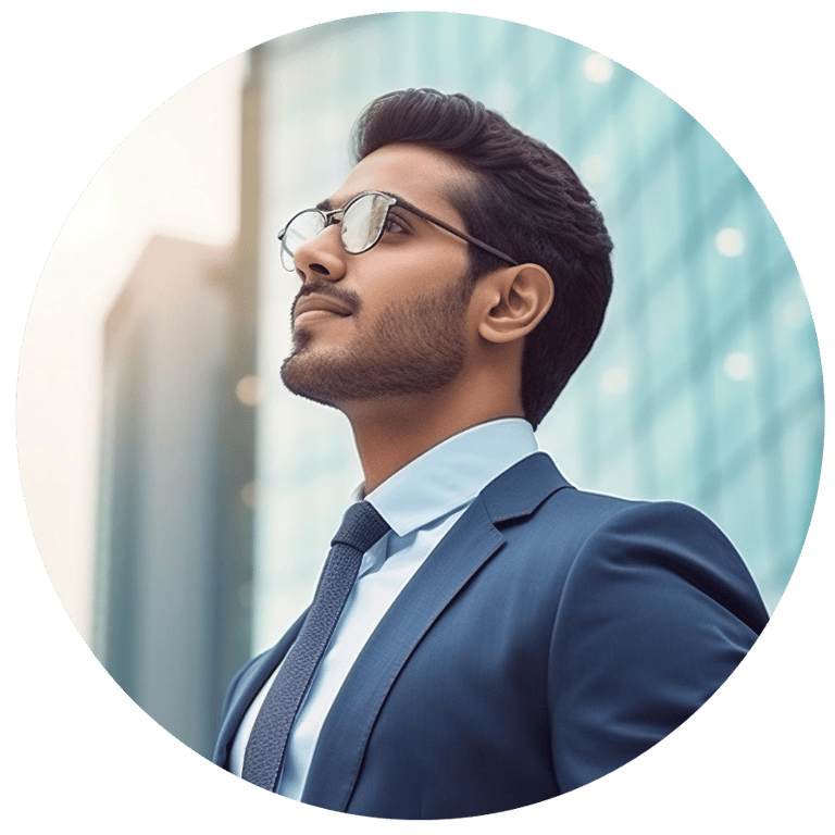 Professional businessman in a blue suit and glasses looking up confidently in front of a city building.