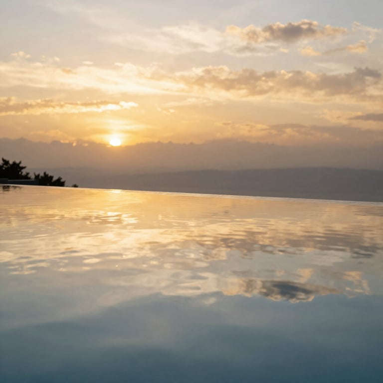 Close-up of a high-end infinity pool reflecting the golden sky in a luxury North American / US backyard setting.