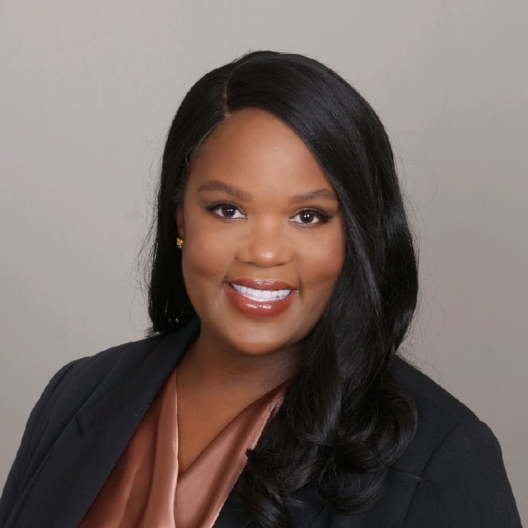 a woman in a black suit and pink blouse