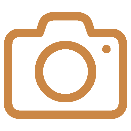 A brown DSLR camera line icon representing photography, media, or digital imaging.