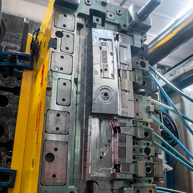 Industrial steel injection mold for plastic manufacturing in a high-precision molding machine.