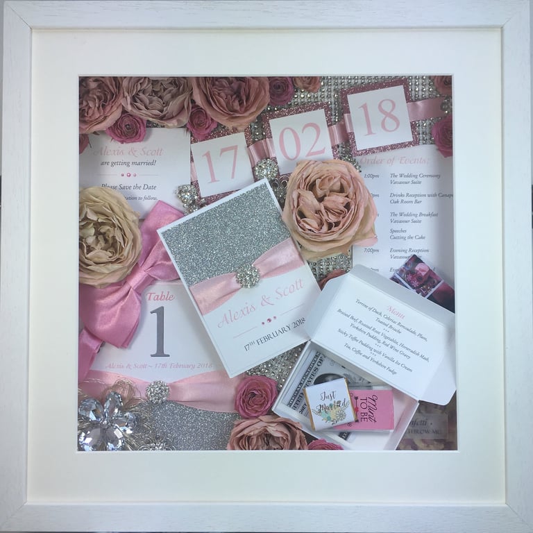 memory box full of wedding items, table numbers, preserved wedding bouquet flowers and diamantés