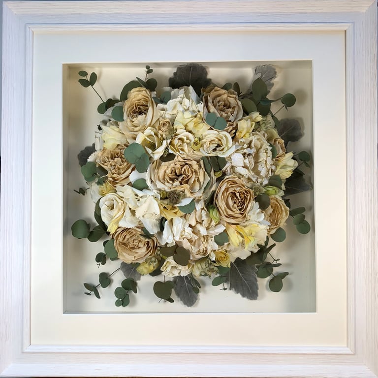 Birdseye view preserved wedding bouquet of ivory and eucalyptus in a frame