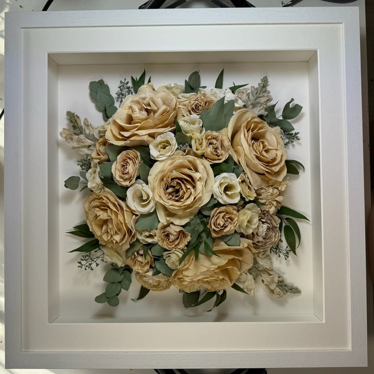 a Birdseye view preserved wedding bouquet in a frame