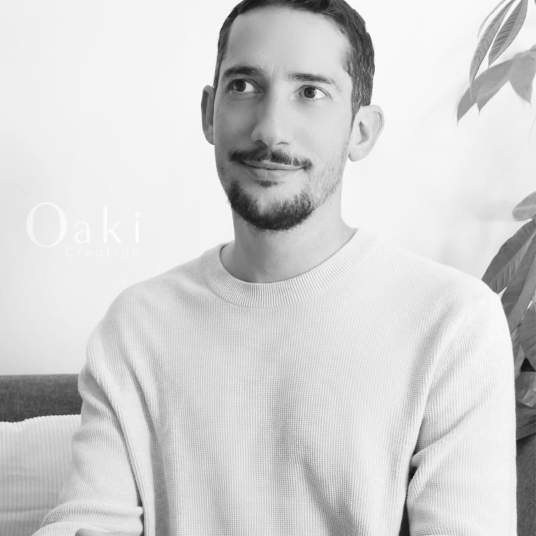 Black and white portrait of a man with a beard and mustache wearing a knit sweater by Oaki Creation.