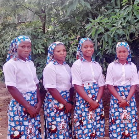 Young women standing together in traditional patterned skirts