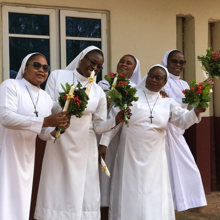 Missionary Sisters of the Divine Image holding flowers during celebration