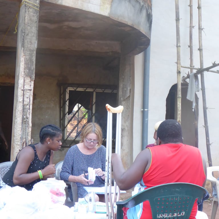 Medical outreach volunteers assisting community member outdoors